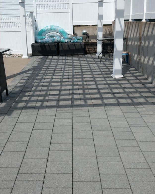 The same patio after pressure washing, clean light pavers
