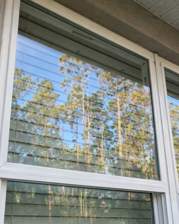 The same window after cleaning, clear glass and a clean sill